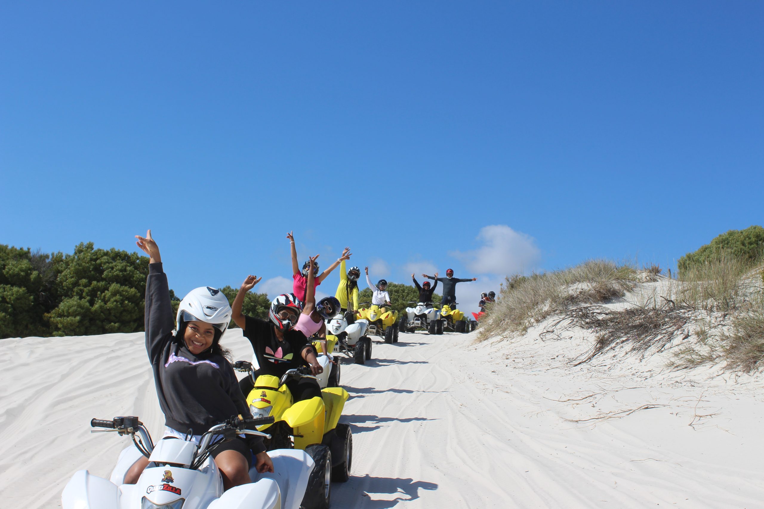 Riders cheering on quad bikes at the Atlantis Dunes near Cape Town